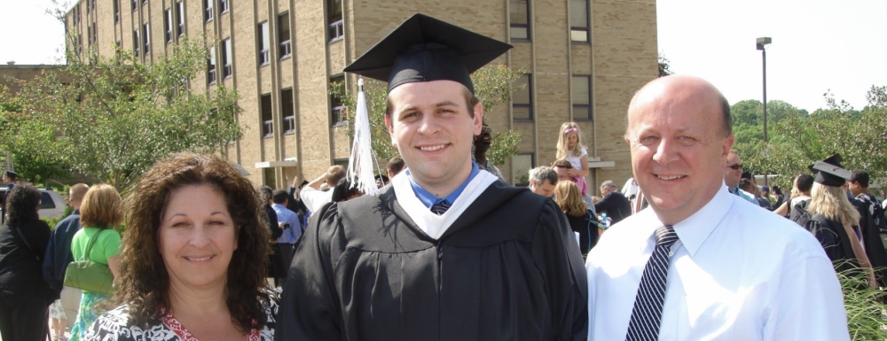 Graduate Justin Cary poses with parents Carol and Jack Cary outside at Xavier University.
